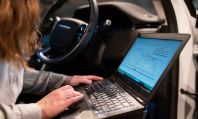 Lady in the car working on the laptop